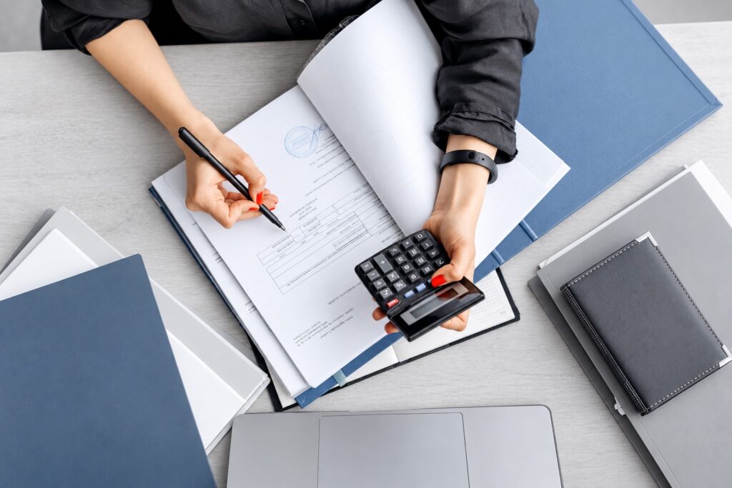 Reviewing a financial document with a calculator and pen